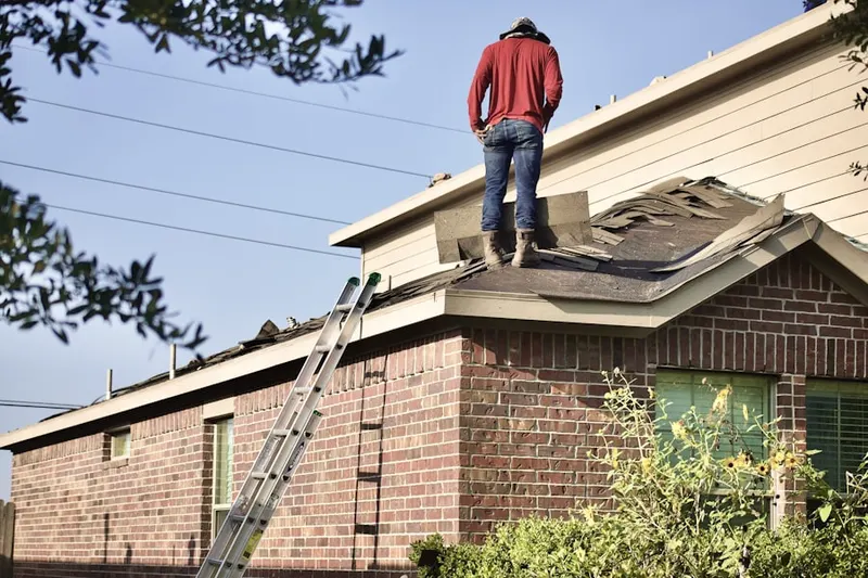 Professional roofer working on a residential roof in Shane